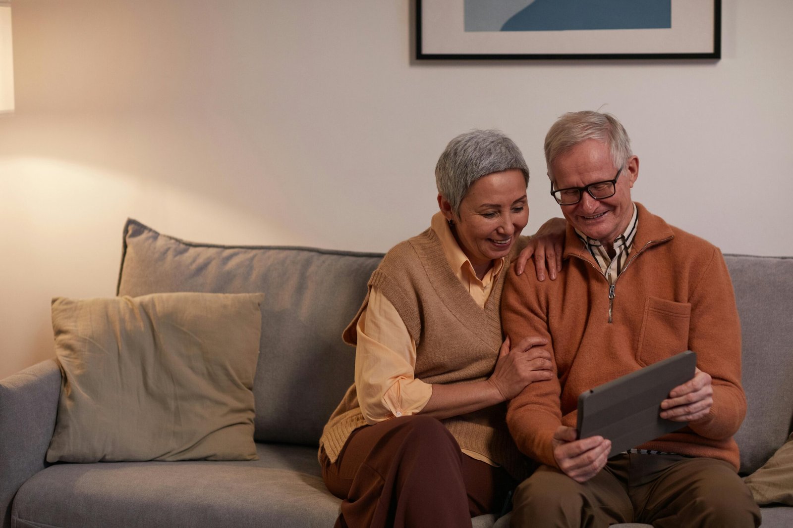 A family using a tablet to control lighting and temperature in a modern vacation rental.